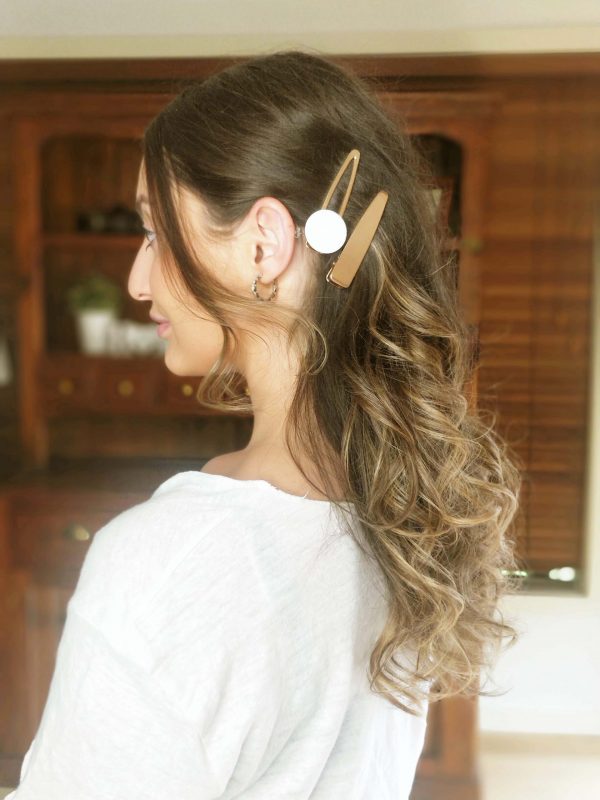 hair pulled back on the side with golden glamour clip set